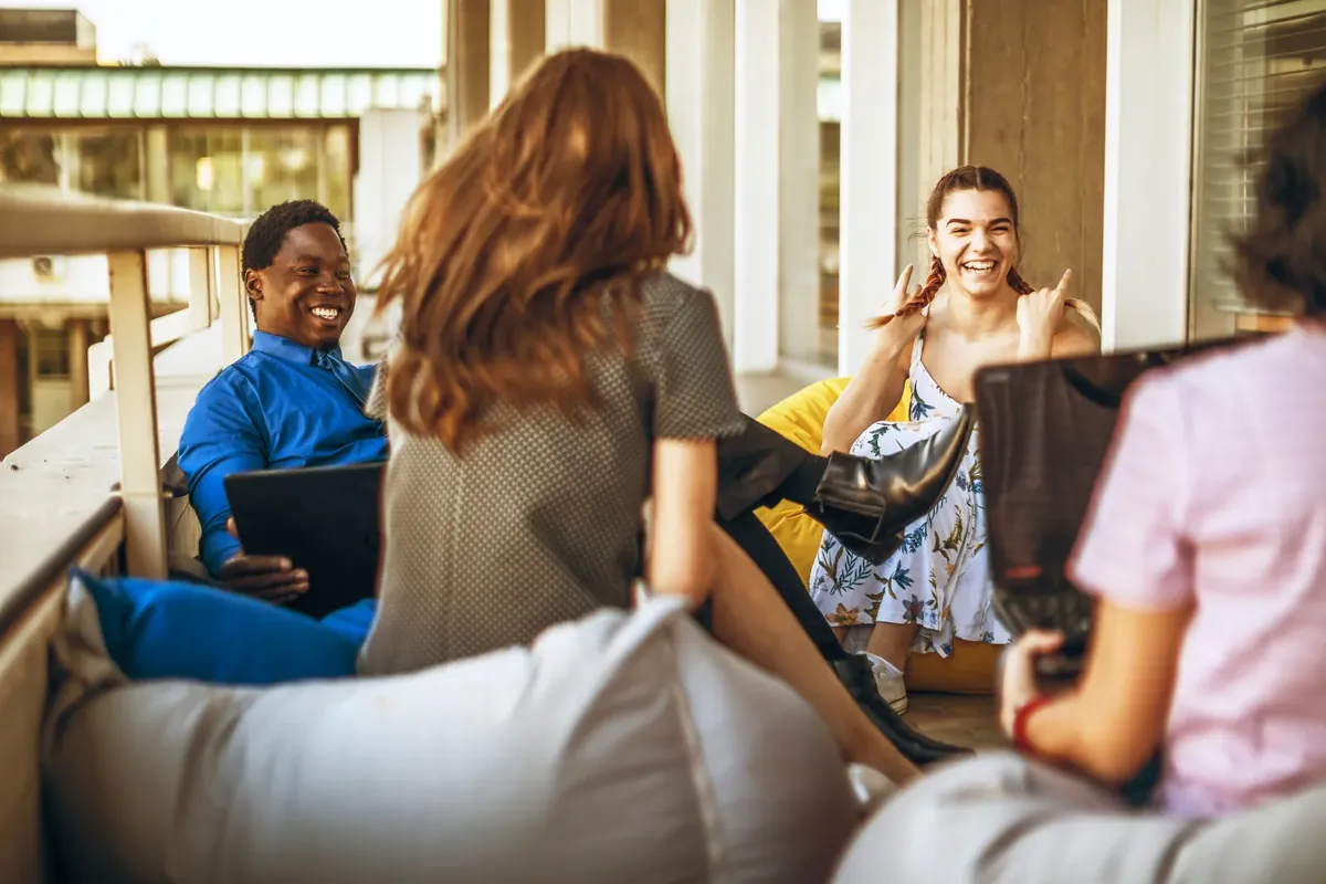 Attendees talking together in a hotel lounge